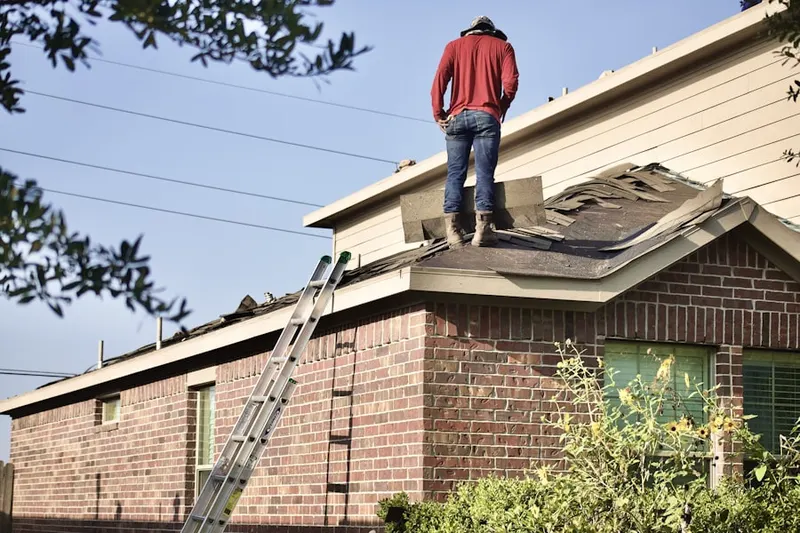 Professional roofer working on a residential roof in East Quogue